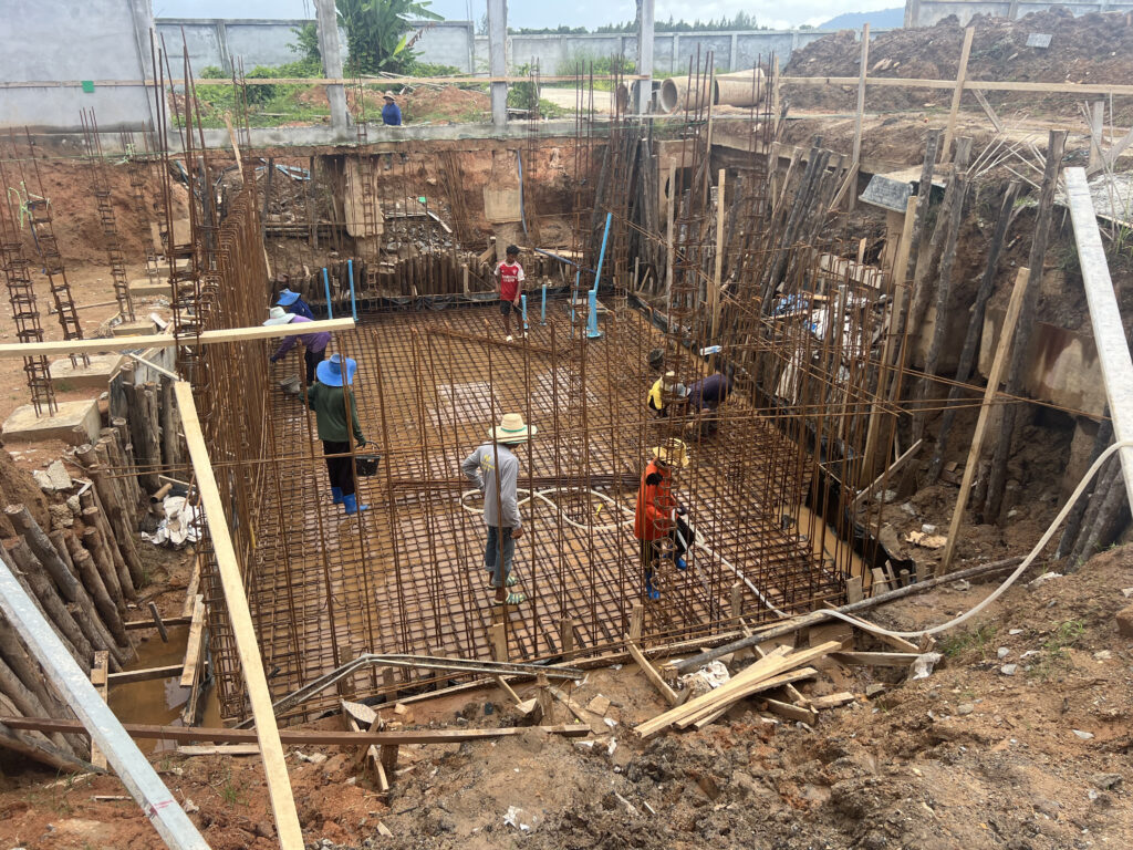 Basement excavation flooded by the water table during the rainy season